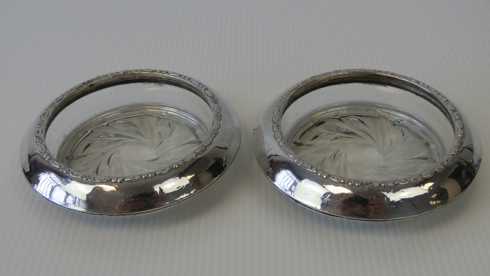 A good pair of glass & Sterling silver edged table salts or bon-bon dishes each 10cm diameter.