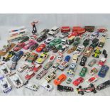 Over 40 unboxed die-cast and molded plastic model racing cars, transporters,