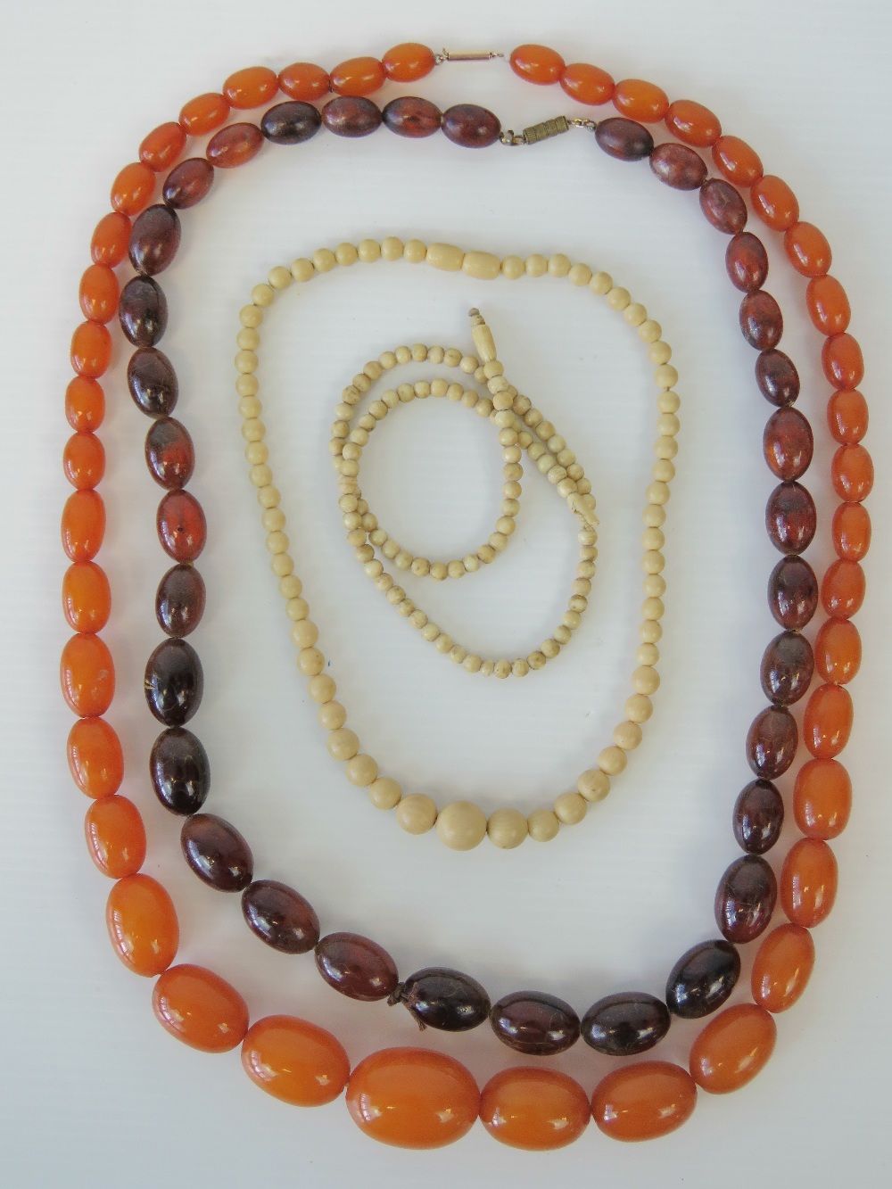 An amber necklace with 9ct gold clasp, graduated oval amber beads, largest 3cm wide, smallest 1.