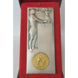 An unusual early 20th Century large medal plaque in silvered finish and bearing Olympic symbology,