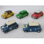 Three SMTS die-cast model racing Mini cars: V8 Mini Sprint and to Mini Coopers together with two