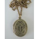 A rose metal Victorian locket with floral engraving, on a 9ct gold belcher link chain, 52cm long,