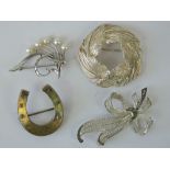 Two silver brooches each of floral form;