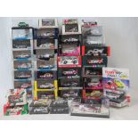 Over 40 die-cast model racing cars all with original packaging including models by Paul's Model Art