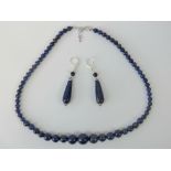 A graduated lapiz lazuli bead necklace with white metal clasp, 50cm long,