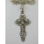 A silver cross in intricate filigree design with oval white stone centre, 6cm long, stamped 925,