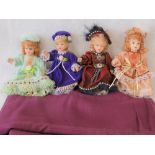 Four contemporary miniature dolls in a variety of traditional costumes, each 15cm high.