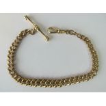 A yellow metal graduated watch chain with lobster clip marked 9ct, 16cm in length.