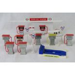 A quantity of model filling station petrol pump equipment, signage and a 'ramp.' Unboxed.