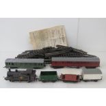 A Hornby 00 47606 0-6-0 locomotive with three wagons,