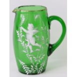 A Victorian Mary Gregory style green glass jug with gilded rim and pontil mark to its base;