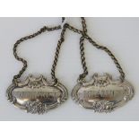 Two silver plated decanter collar tags; whiskey and brandy, grape design, complete with chains.