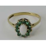 A 9ct gold opal and emerald ring,