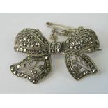 A silver and marcasite bow brooch,