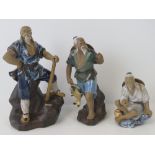 Three ceramic figures of oriental fishermen, missing fishing rods; largest 24cm high.