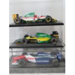 Two Tamiya die-cast models of F1 racing cars including a Lotus 107B Ford together with another;