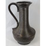 A large ribbed ceramic ewer with lustre glaze (50cm high).