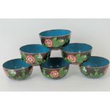 Six matching black-ground cloisonné bowls each measuring 11cm diameter. Floral decoration to each.