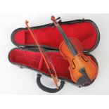 A contemporary miniature violin together with bow and case, violin 17cm in length.