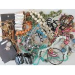 A quantity of vintage and modern costume jewellery to include; shell bracelets, bangles, necklaces,