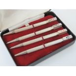 A four piece HM silver bridge pencil set, each with a different suit to terminal,