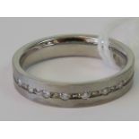 An 18ct white gold and diamond set ring, central channel set with seven round cut diamonds,