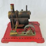 A scale model live steam stationary single piston engine by Mamod.