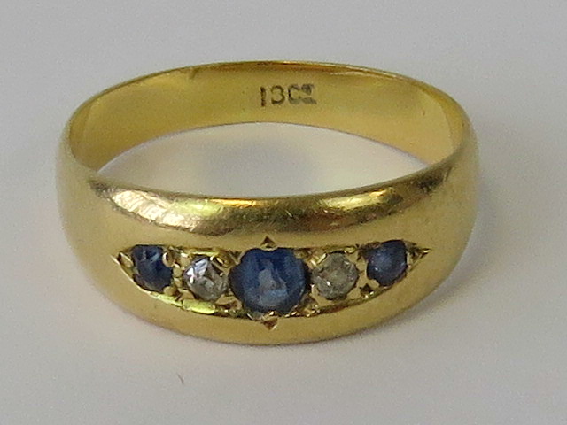 An 18ct gold sapphire and diamond gypsy ring,