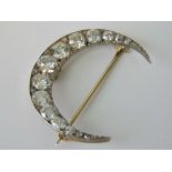 A fine quality crescent moon brooch containing twenty-one graduated old Victorian and Rose cut