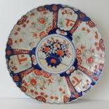 A Chinese white ground charger decorated in red and blue with rural scene, birds and foliage,