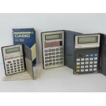 Three vintage c1970s pocket calculators, two by Casio and one Texas Instruments.