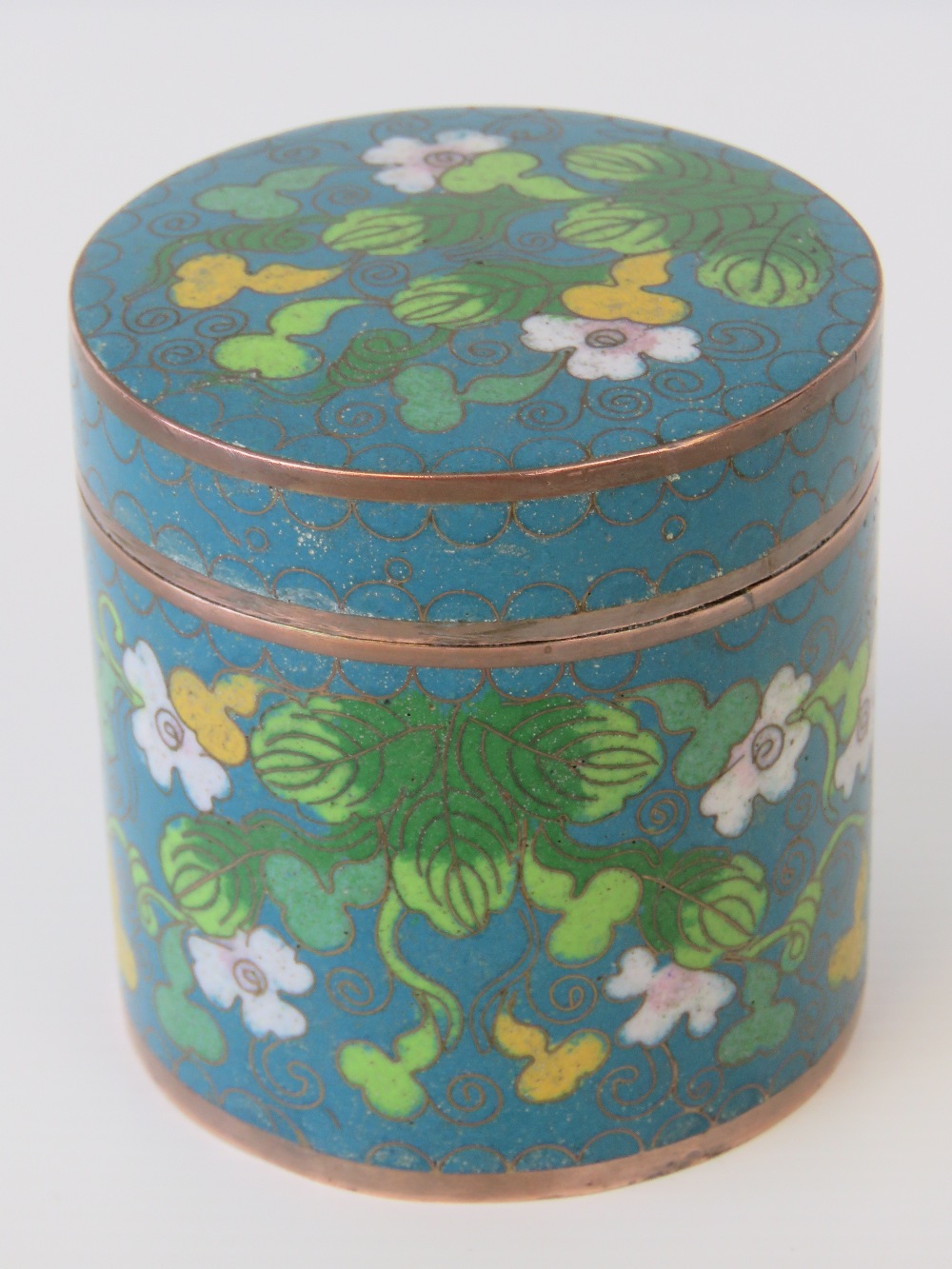 A turquoise ground cloisonné lidded pot standing 8cm high and 8cm diameter having floral decoration