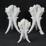 A pair of ivory ground triform cornucopia leaf table vases,