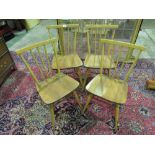 Four smart elm seated Ercol 'light wood' dining chairs, bearing original stickers upon.