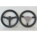 Two leather bound racing car steering wheels, one marked MotoLitre,