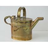 A good Edwardian brass hot water can with hinged lid and loop handle, 24cm high.