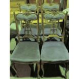 Four Edwardian pierced splat overspung dining chairs.