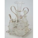 A high Victorian silver plated table cruet set, complete with engraved glass epern centrepiece,