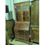 A 20th century bureau bookcase with astral glazed top; 199cm high.