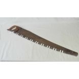 A vintage late 19th century saw having wooden handle and substantial blade,