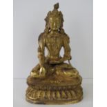 A late 19th century Chinese gilt bronze figure of Buddha, seated upon a raised stand; 22cm high.