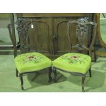 A good pair of Victorian pierced and shaped mahogany framed fireside chairs each with yellow ground