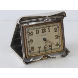 Cartier; a delightful and rare vintage sterling silver eight day travel clock by Cartier in the form