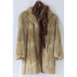 A vintage fur coat together with two stoat fur stoles.
