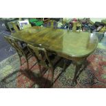 A fine quality extending dining table in walnut by Maples.