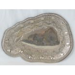 An Indian silver plated tray of unusual shaped form with scrolling foilage and disc design,