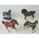 Four horse figures, largest 20cm high.