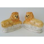 A pair of Staffordshire lions, 27cm.