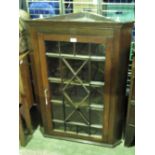 An astral glazed hanging corner cabinet,