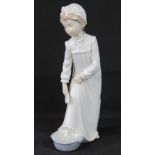A Nao figurine of a girl in nightdress w